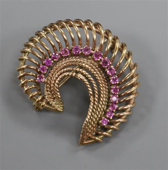 A pierced yellow metal and gem set scroll brooch, 40mm.